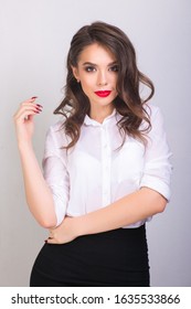 Portret Of Young Woman In White Shirt And Black Skirt With Red Lips On White Background. Buisness Woman