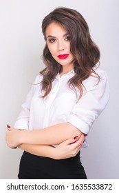 Portret Of Young Woman In White Shirt And Black Skirt With Red Lips On White Background. Buisness Woman