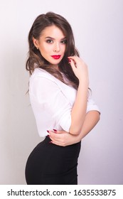 Portret Of Young Woman In White Shirt And Black Skirt With Red Lips On White Background. Buisness Woman