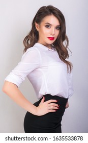 Portret Of Young Woman In White Shirt And Black Skirt With Red Lips On White Background. Buisness Woman