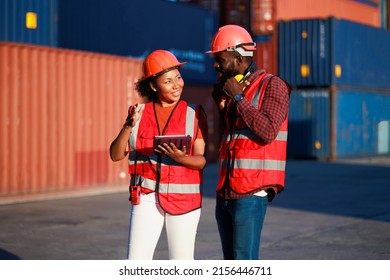 Portriat Handsome Male African American Industrial And Female Cock Warehouse Specialist. Black Man Worker Wearing Yellow Protective Hard Hat Helmet Working At Container Yard.