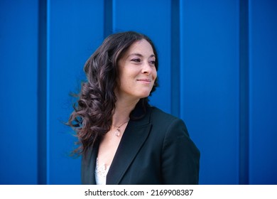 Portriat Of Happy Successful Businesswoman Commuter Against Blue Wall Outside In Street.