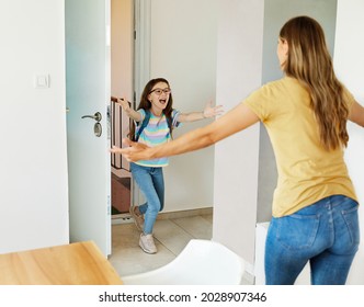 Portriat Of A Young Teen School Girl With Backpack Welcomed By Her Mother After Coming Back From School At Home