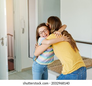 Portriat Of A Young Teen School Girl With Backpack Welcomed By Her Mother After Coming Back From School At Home