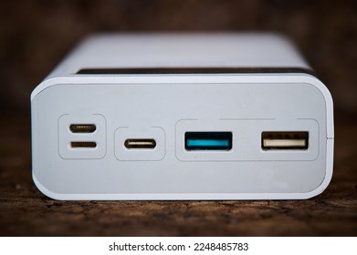 ports of a large power bank close up on a wooden background