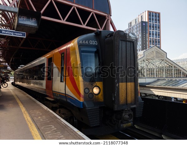 PORTSMOUTH,\
ENGLAND - July 20 2021: A South Western Railway train arrives at\
Portsmouth and Southsea railway\
station