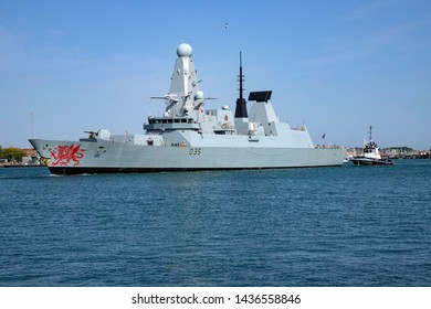 Portsmouth, Hampshire, UK June 28 2019 Daring Class Destroyer HMS Dragon Leaving Port Escorted By Tugboat SD Independent