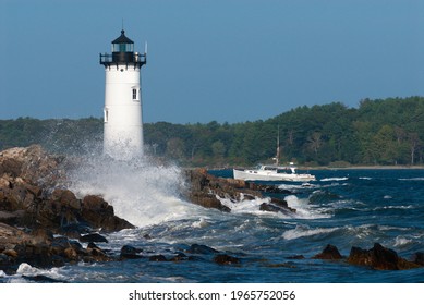 Portsmouth Harbor Lighthouse, Also Known As Fort Constitution Light, Guides A Fishing Boat Through Rough Seas Into The Harbor In Seacoast New Hampshire. A Favorite Tourist Attraction In New England.