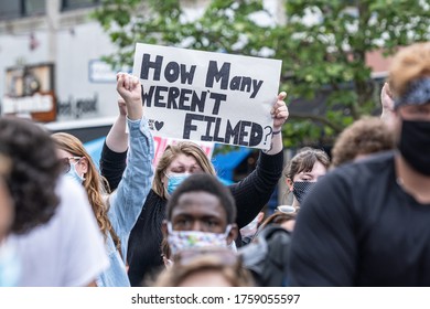 Portsmouth, New Hampshire (USA) - June 7th, 2020).  Thousands gathered at Market Square to request justice for George Floyd. Sign with "How many weren't filmed" - Shutterstock ID 1759055597
