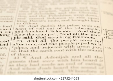 Portsmouth, NH, USA - March 14, 2023: Close up of 1 Kings 1:39-40 in the King James Bible. Highlighting God save king Solomon - Powered by Shutterstock