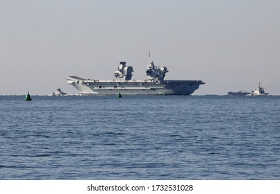 PORTSMOUTH, UK – 15TH MAY 2020: The Royal Navy Aircraft Carrier HMS QUEEN ELIZABETH Weighs Anchor And Heads Through The Solent To Continue Its Trials And Training Programme