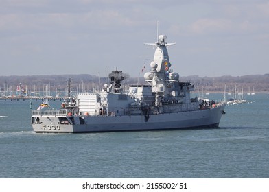 PORTSMOUTH, UK – 18TH MAR 2022: A Tug Guides The Belgian Navy Ship BNS LEOPOLD 1 Towards A Berth. The Karel Doorman Class Frigate Is Making A Short Visit To The Naval Base