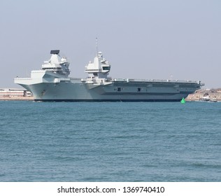 PORTSMOUTH, UK – APRIL 1ST 2019: The Royal Navy Aircraft Carrier HMS QUEEN ELIZABETH Sails For Rosyth, Scotland Where She Will Undergo A Docking And Maintenance Period