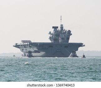 PORTSMOUTH, UK – APRIL 1ST 2019: The Royal Navy Aircraft Carrier HMS QUEEN ELIZABETH Sails For Rosyth, Scotland Where She Will Undergo A Docking And Maintenance Period