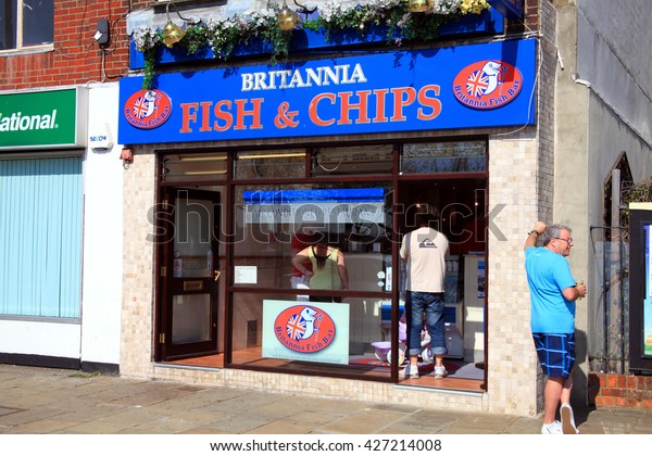 Portsmouth,\
UK, April 22, 2011 : Britannia Fish & Chips shop at The Hard,\
Portsea, serving customers in the city of Portsmouth while a male\
holiday maker drinks a pint of beer\
outside