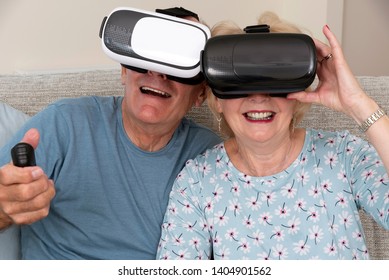 Portsmouth UK, May 2019. Elderly couple having fun wearing virtual reality goggles - Powered by Shutterstock