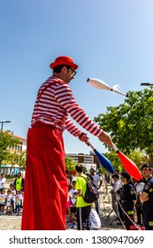 Santarém, Portugal - April 20, 2019: Juggler On Stilts Entertaining The Crowd, Street Performer