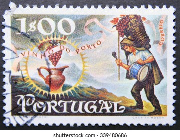PORTUGAL - CIRCA 1970: a stamp printed in Portugal dedicated to wine of Oporto, shows Worker Carrying Basket of Grapes and Jug, Port Wine Export, circa 1970