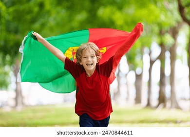 Portugal football supporter kid on stadium. Portuguese soccer fan boy. Happy child with national flag and jersey cheering for Portugal. Championship game support. - Powered by Shutterstock