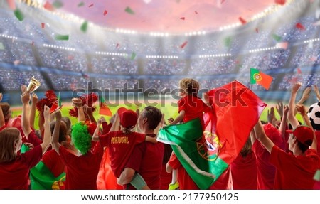 Portugal football supporter on stadium. Portuguese fans on soccer pitch watching team play. Group of supporters with flag and national jersey cheering for Portugal. Championship game. 