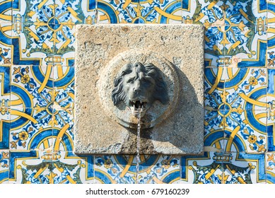 Portugal, fountain with azulejos and head of lion sculptured in the stone