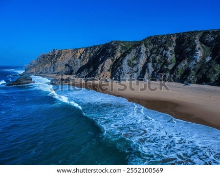 Similar – Aerial Drone View Of Blue Ocean Waves And Beautiful Sandy Beach Shore in Portugal