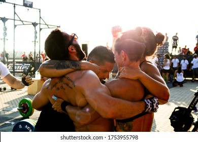 Ílhavo / Portugal - July 23, 2018: Team Of Athletes Embracing In A Circle Celebrating A Victory At A CrossFit Event. Candid Photo. Teamwork And Victory Concept