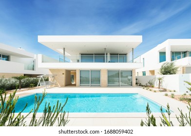 Portugal, Lagos, 05 April 2018 - illustrative editorial. White villa, cottage, luxury house for recreation with swimming pool, terrace with a view, balcony, modern design.