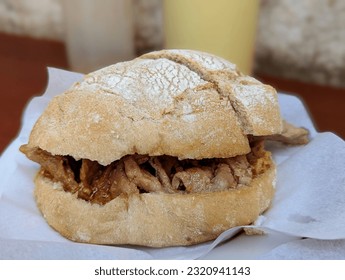 Portuguese Bifana Stewed Pork Sandwich on Roll with Meat Jus in Porto, Portugal, Side View