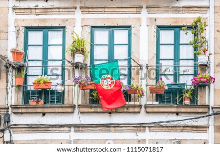 Portuguese flag on the balcony at house in Braga, Portugal