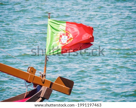 Similar – Image, Stock Photo Portuguese flag on boat in front of old town of Porto / Portugal