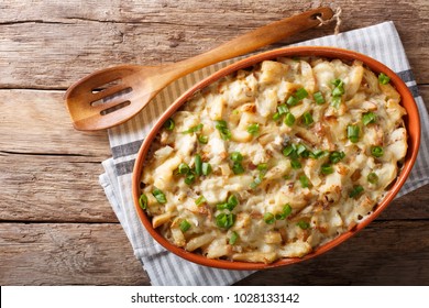 Portuguese Food: Casserole With Cod, Potatoes, Onions And Cream In A Baking Dish Close-up On The Table. Horizontal Top View From Above
