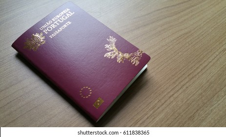 Portuguese passport on wooden background