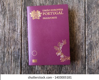 Portuguese passport with wooden background