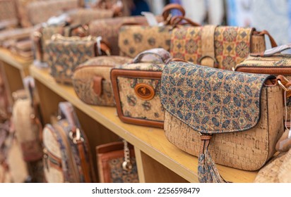Portuguese souvenirs, brown cork bags, at the street market at the Nazare, Portugal. - Shutterstock ID 2256598479