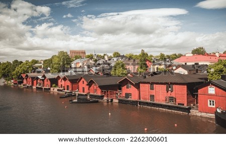 Porvoo old town on a sunny day, Finland. Traditional red wooden Finnish houses and barns are on the river coast. Vintage toned landscape photo