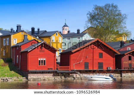 Porvoo town, Finland. Old red wooden houses on the river coast in sunny day