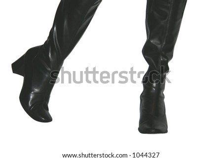 Posed feet isolated in black women's fashion boots