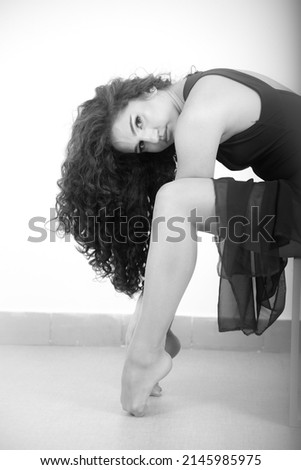 Similar – Young brunette woman in black lingerie lying on the floor