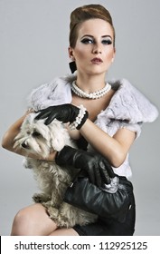 Posh, Rich Lady Is Holding A Sweet Maltese Dog