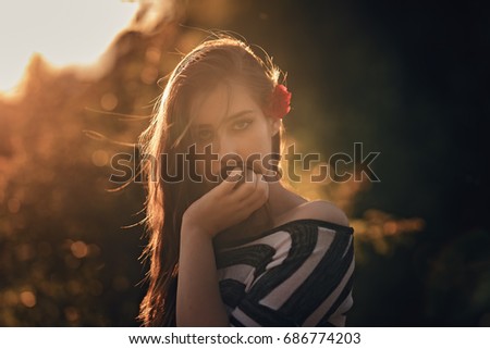 Similar – Portrait of a girl in red dress on a wooden door