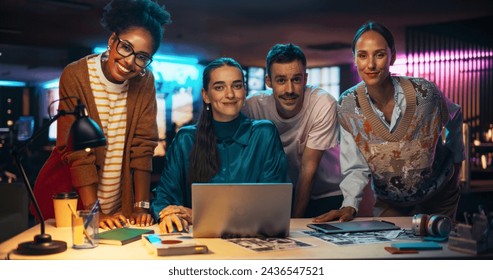 Posing Shot of a Diverse Group of Talented Young Business People Gathered Around a Desk in a Modern Creative Office, Brainstorming. Multiethnic Teammates Looking at Camera and Smiling - Powered by Shutterstock