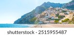 Positano, Amalfi Coast, Italy. View of Spiaggia Grande beach and old town on a sunny spring day. Green Mountains on the background. Banner header image.