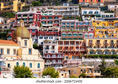 Positano on the famous Amalfi Coast in Campania Italy. Picturesque historic village with colorful houses and church built on the steep coastline. Summer atmosphere in popular tourist destination.  - Shutterstock ID 2206715435