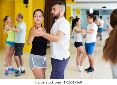 Positive Adults Dancing Salsa Together In Dance Hall