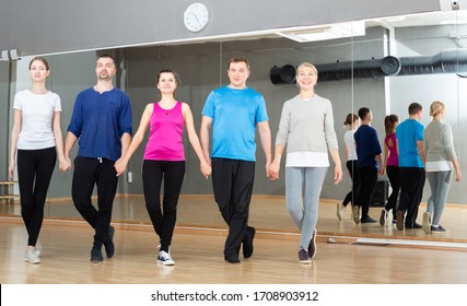 Positive Adults Forming Line While Rehearsing Traditional Irish Stepdance In Dance Studio