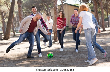 Positive Adults Friends Chasing Ball Outdoors At Sunny Day