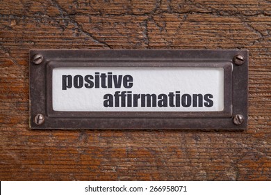 Positive Affirmations - File Cabinet Label, Bronze Holder Against Grunge And Scratched Wood