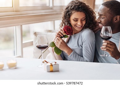 Positive African American Couple Hugging In The Restaurant