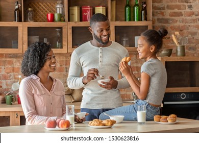 Positive African American Family Having Breakfast In Beautiful Kitchen, Talking While Eating, Free Space